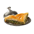 Klassisches Pistazien-Baklava in Rautenform mit goldbraunem Blätterteig und grüner Pistazienfüllung